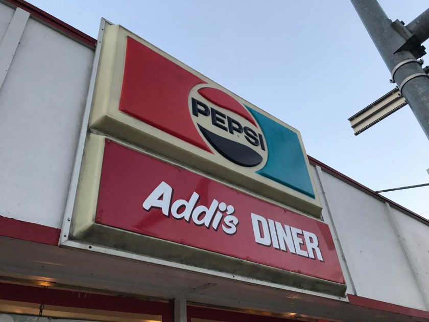 Sign for Addi’s seen from the road