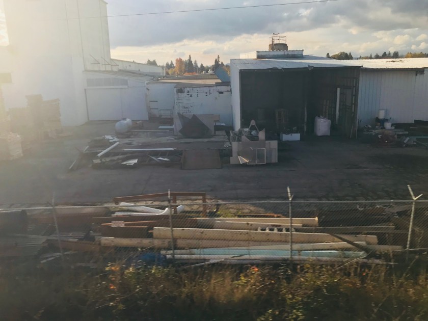 Building materials stacked against the train’s fence