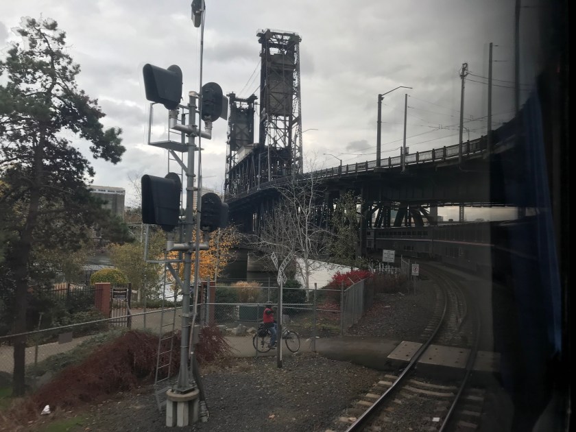 On the train traveling under regular car traffic on one of Portland's bridges