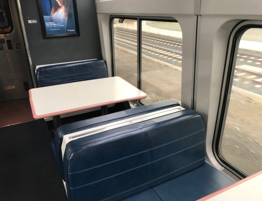 The tables in the socializing car are my preferred spot