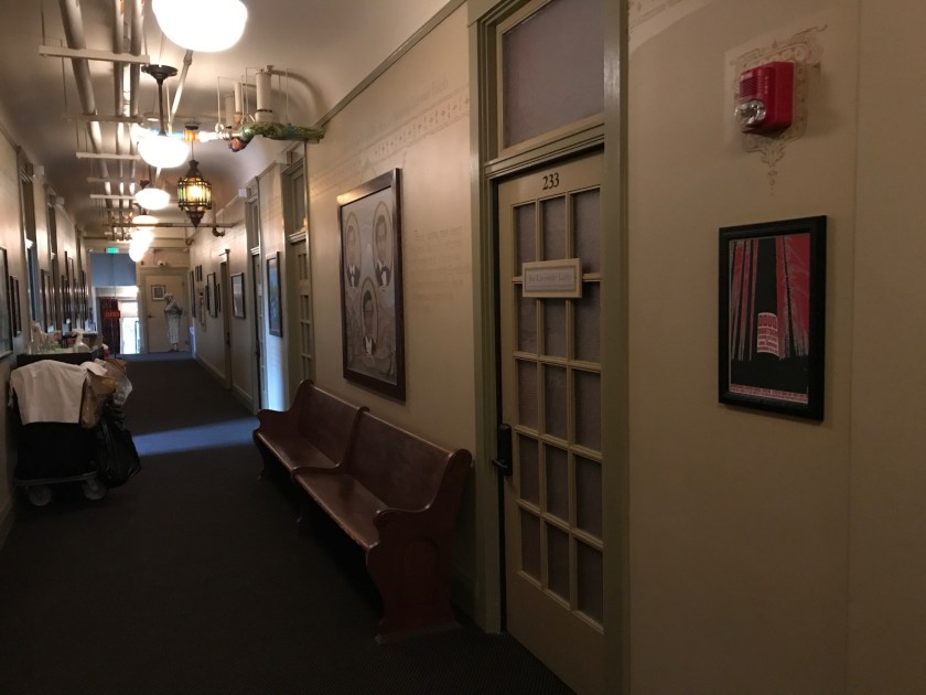 Another view of the second floor hallway with benched and artwork