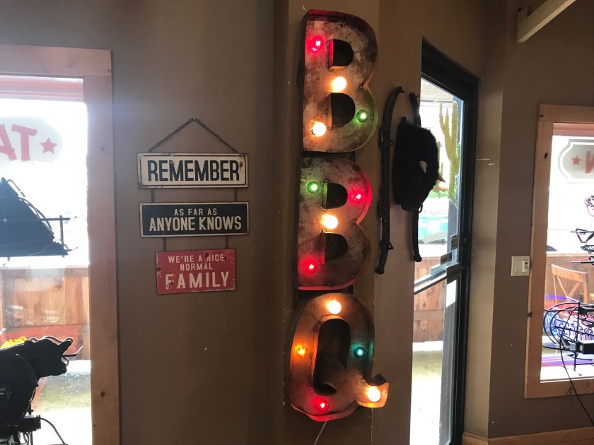The BBQ sign and normal family signs just near the exit to the outside seating area